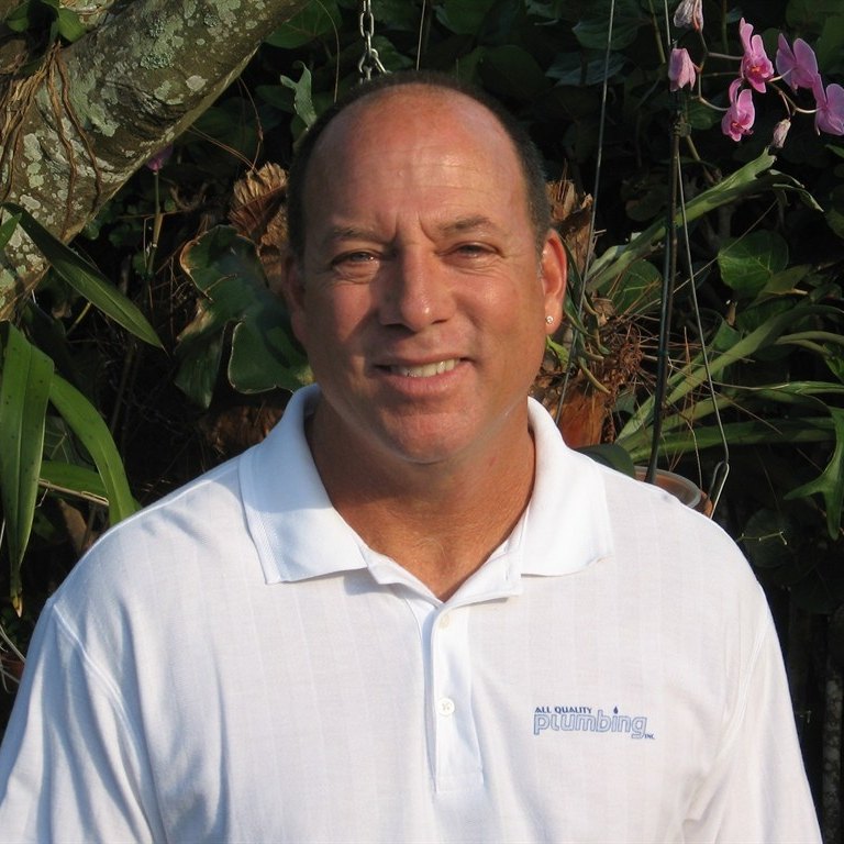 James Woolfe, owner of All Quality Plumbing, outside in a company shirt