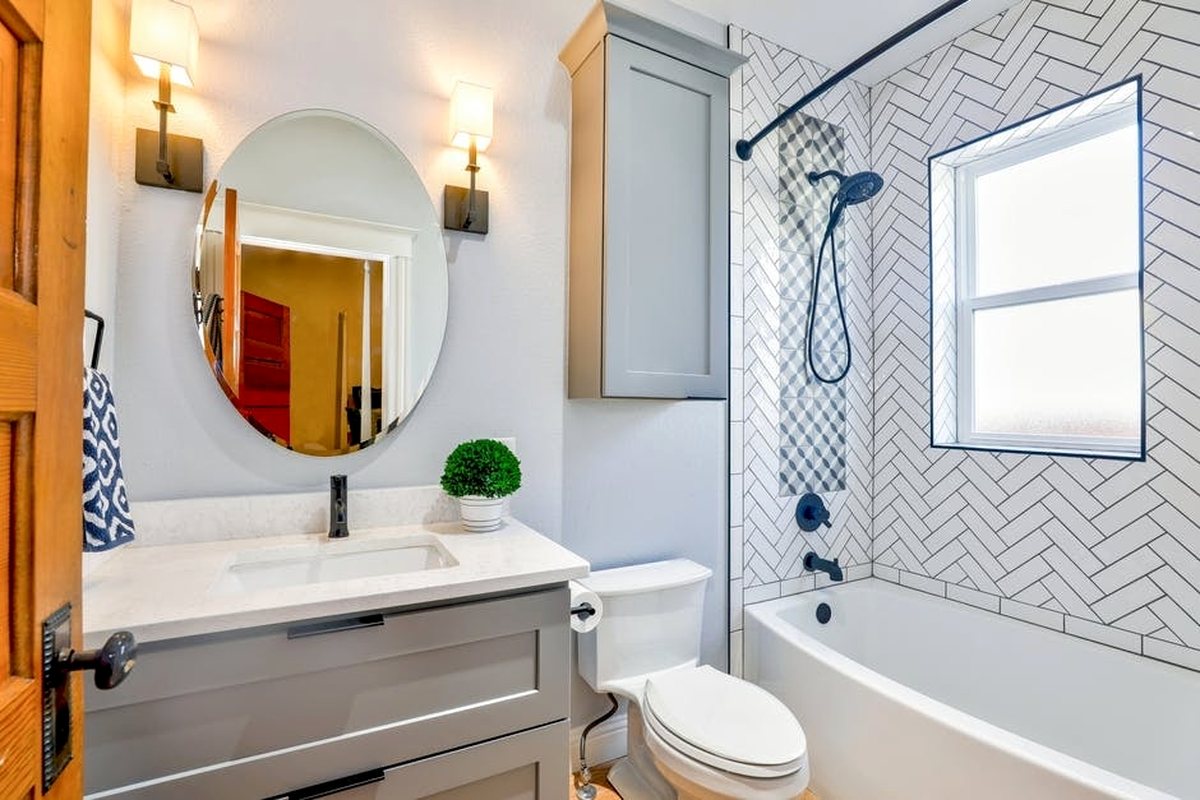 A finished bathroom with a newly installed toilet and vanity