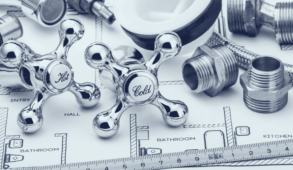 Plumbing tools laid out before a drain cleaning job
